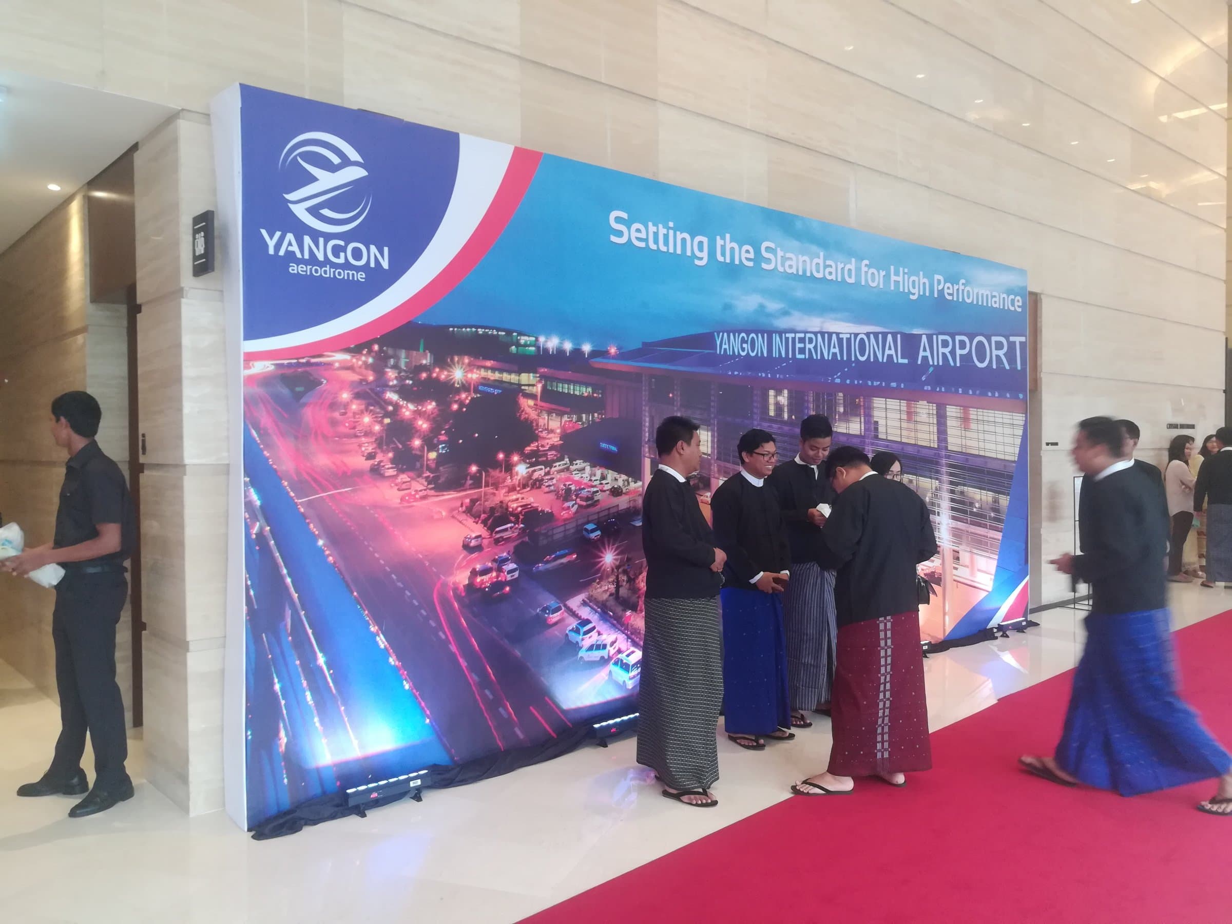 Terminal-panorama backdrop with guests arriving