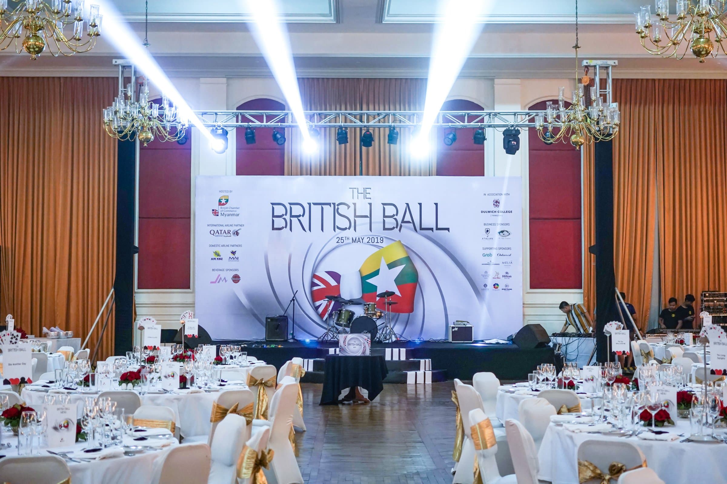 The ballroom set for the night, gun-barrel stage beyond