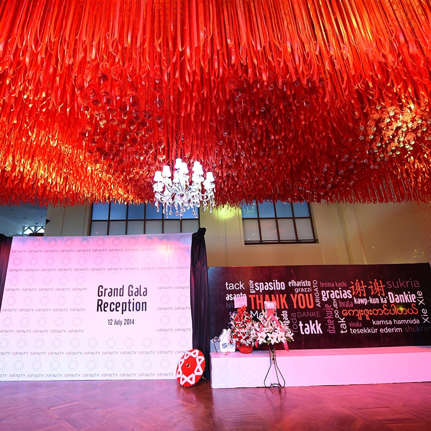 'Thank you' in twelve languages — the gala's red installation wall