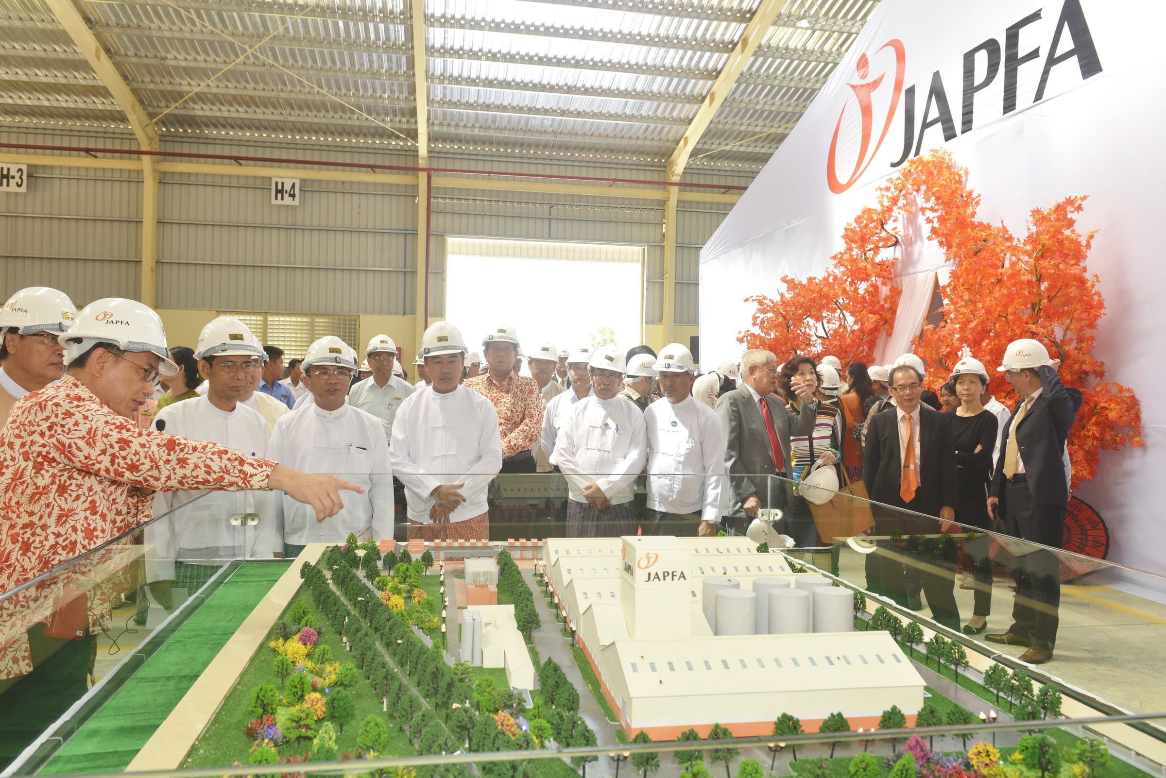 Officials at the scale model of the plant