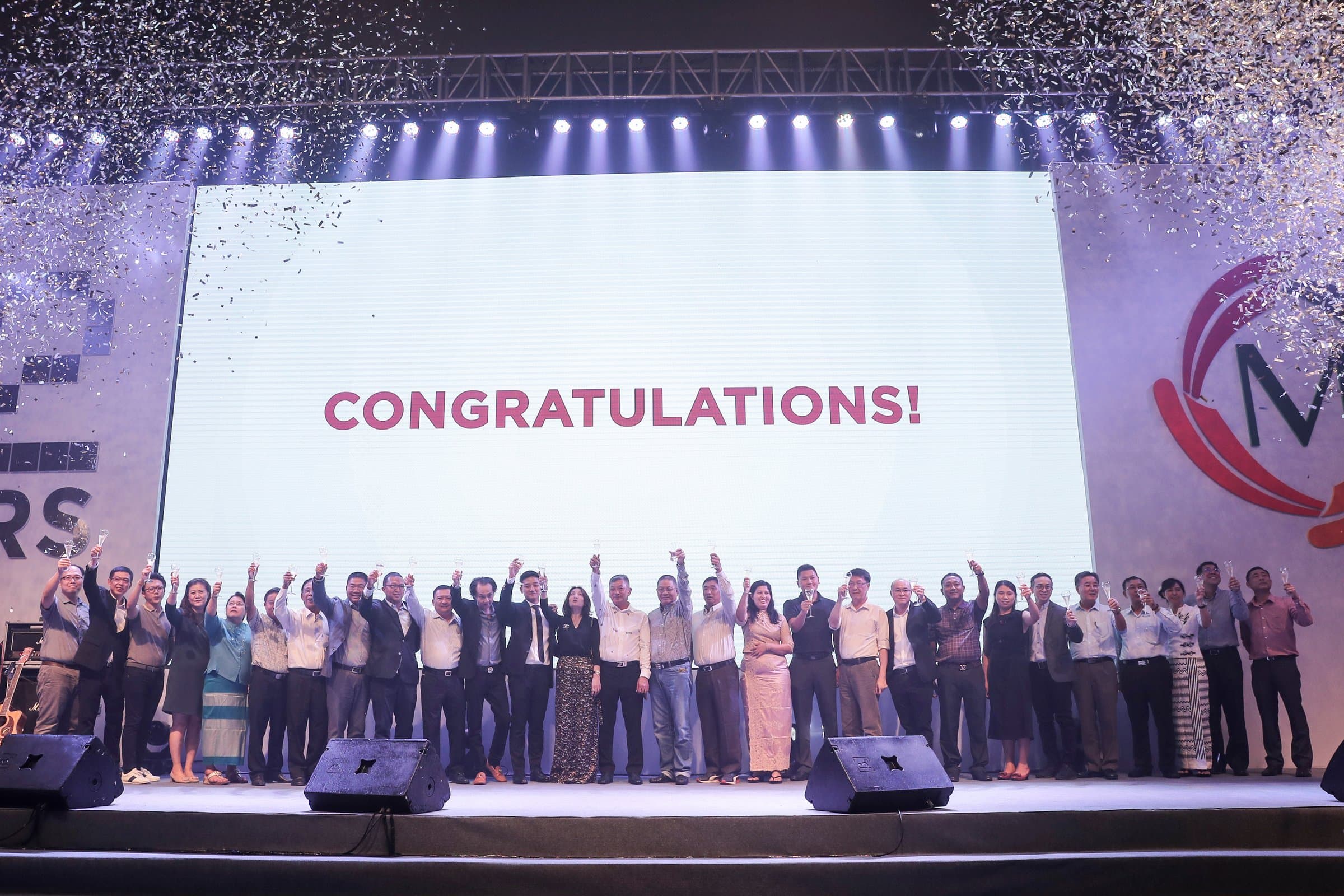 Congratulations — confetti over the whole company on stage