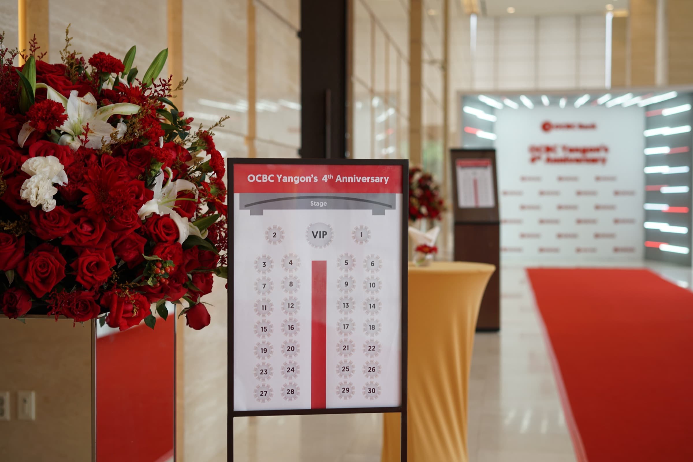OCBC Yangon anniversary — entrance with seating plan and light-wall backdrop