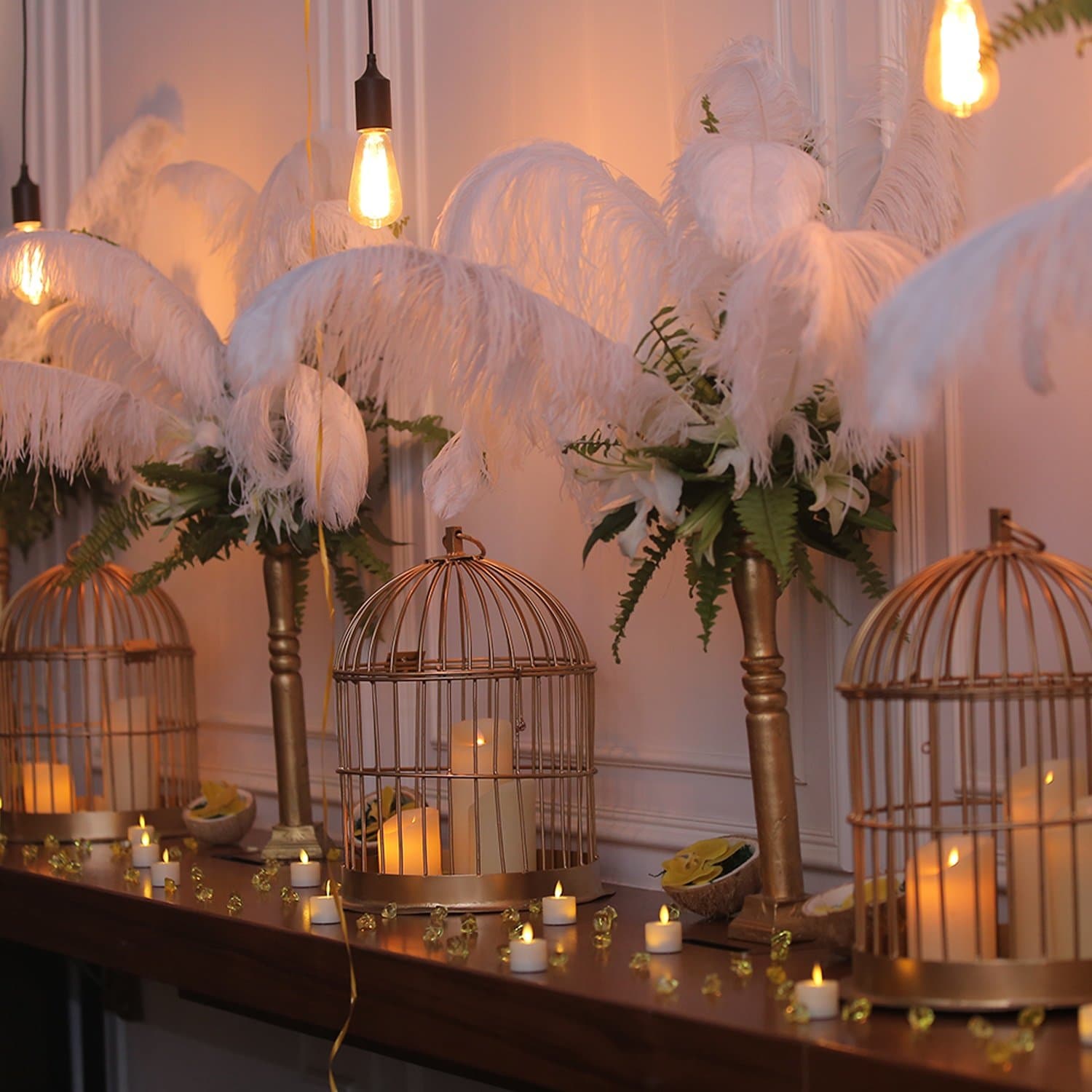 Feather and birdcage centrepieces with candlelight