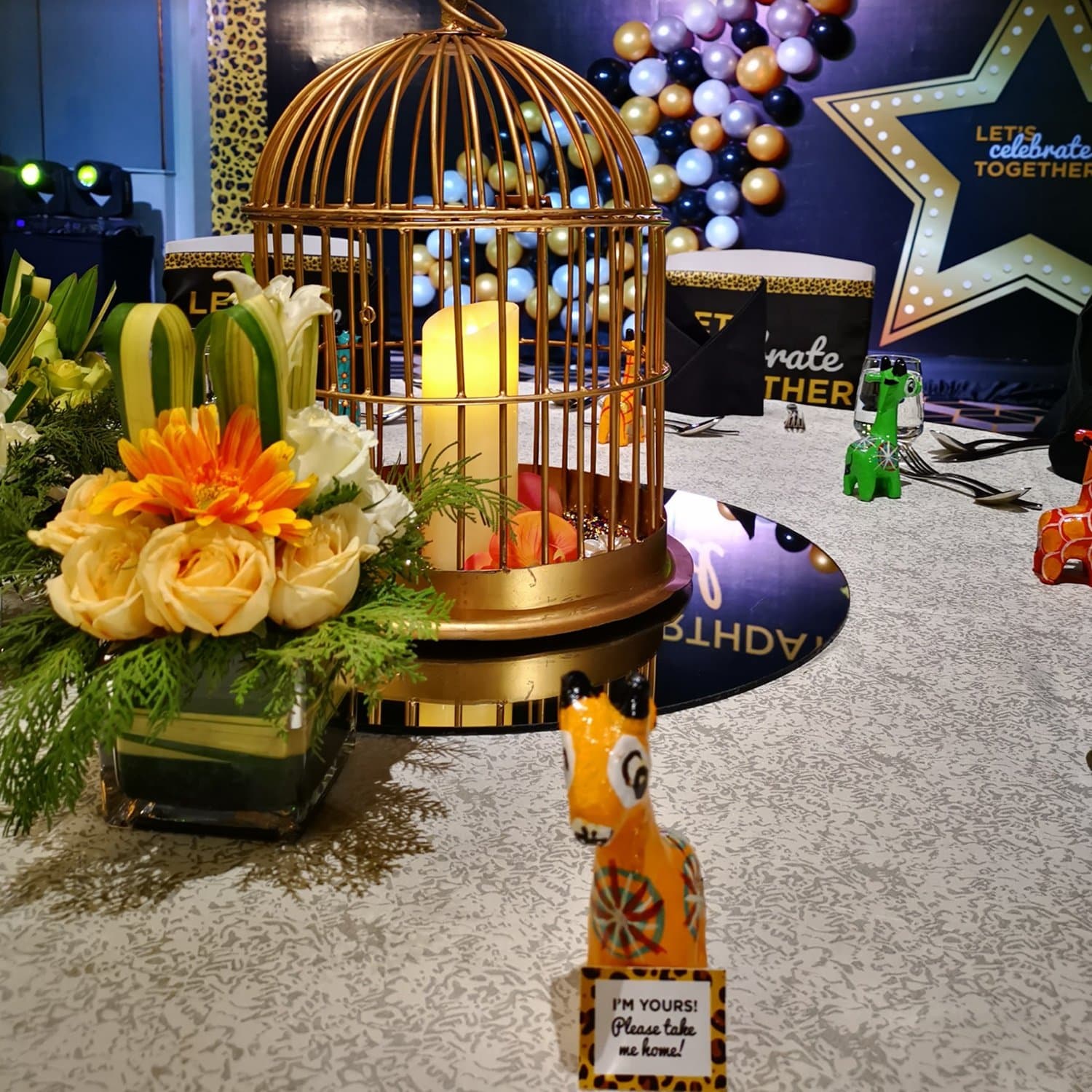 Themed table setting with gilded birdcage centrepiece