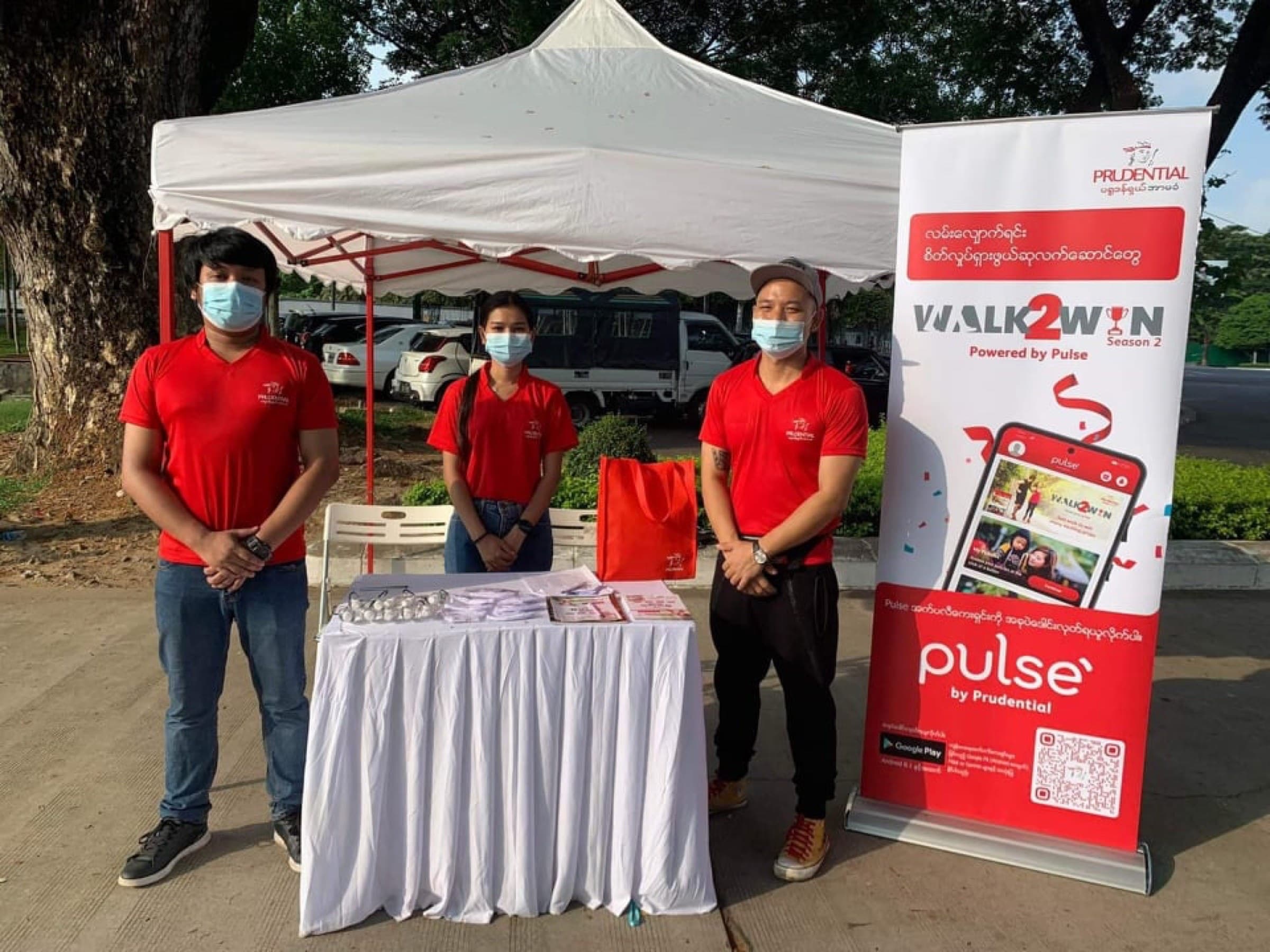 Walk2Win Season 2 park booth with Pulse app banner