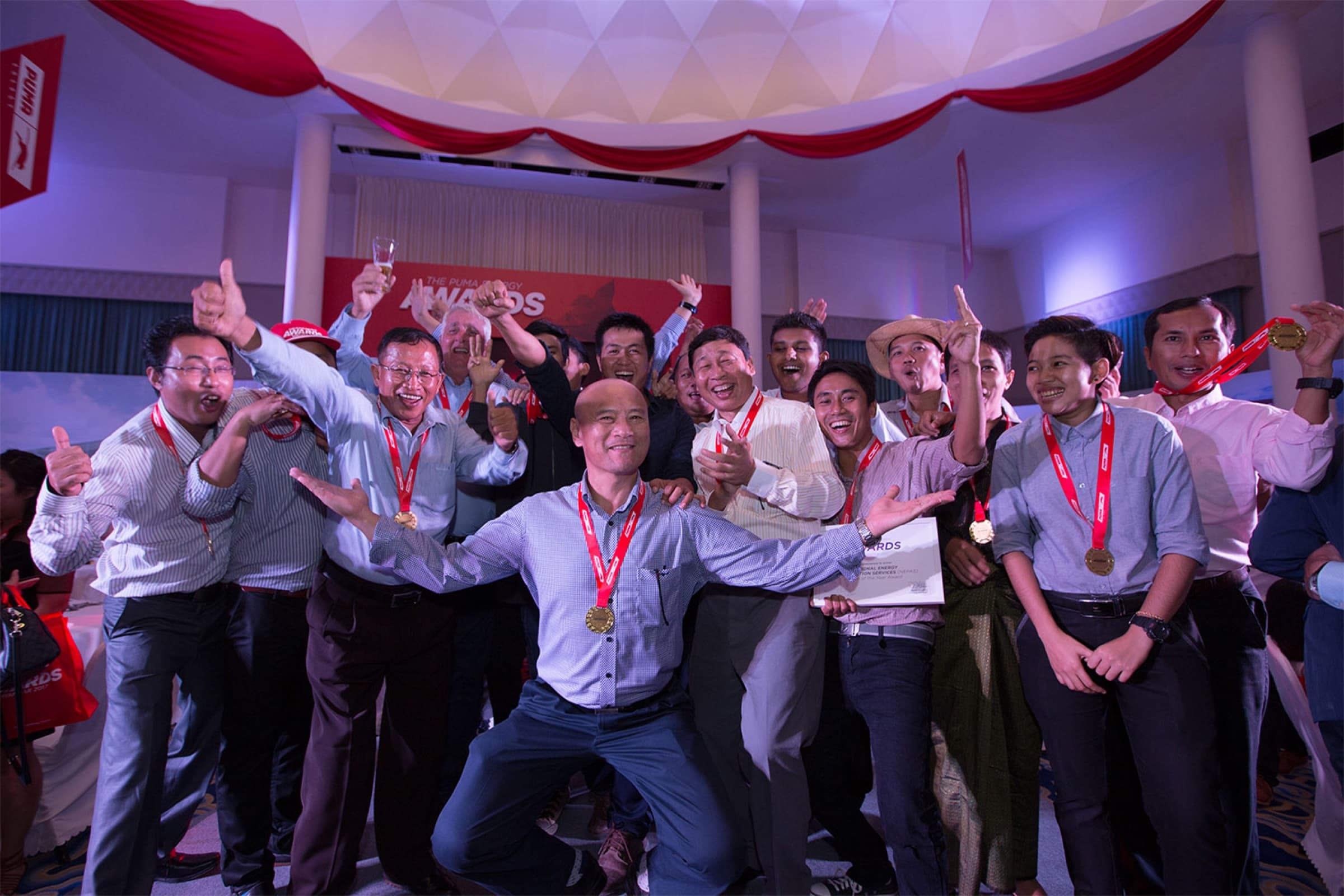 Winning team celebrating in front of the stage