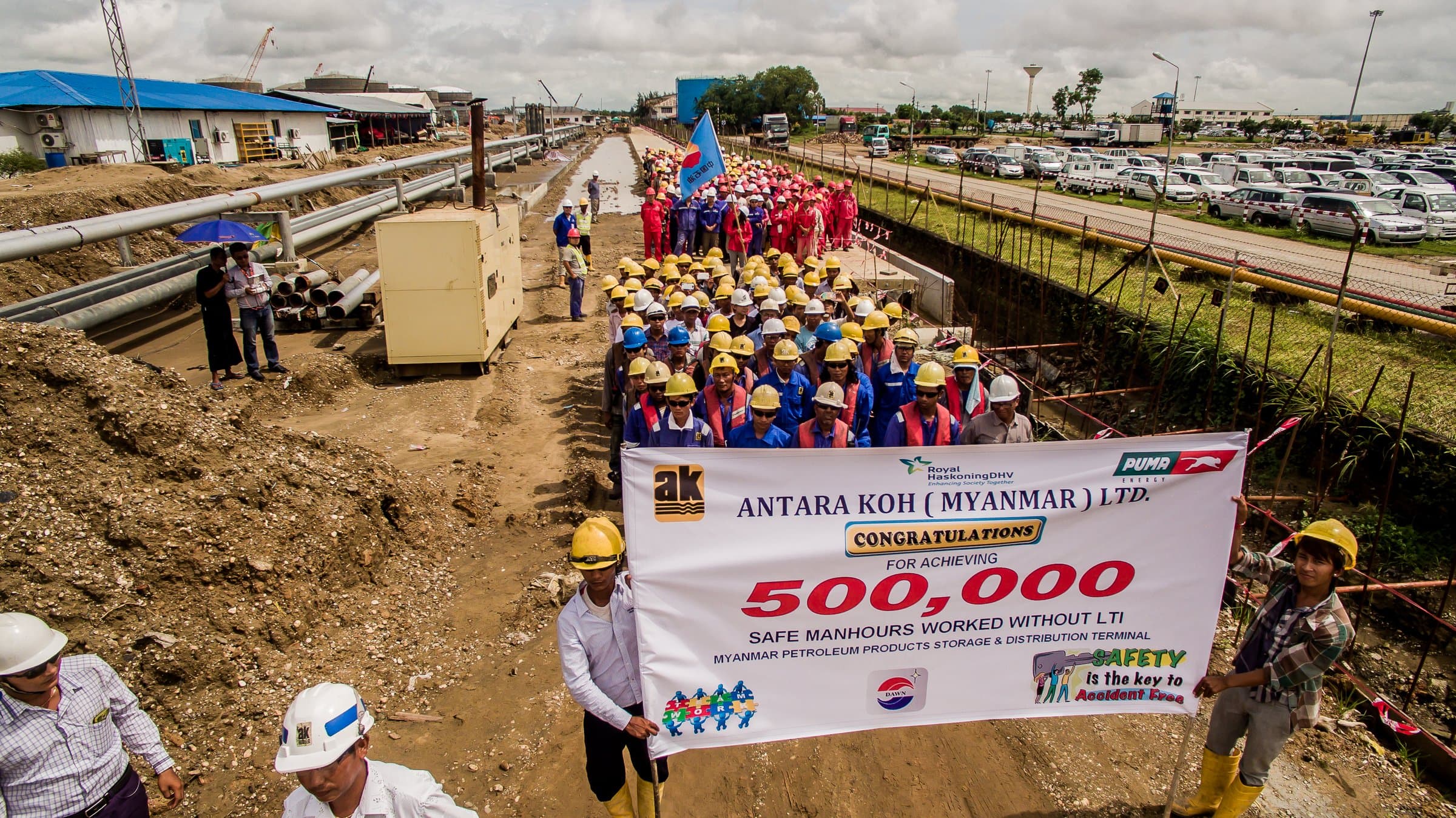 The workforce behind the milestone, banner aloft